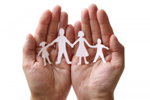 hand holding paper family cutout